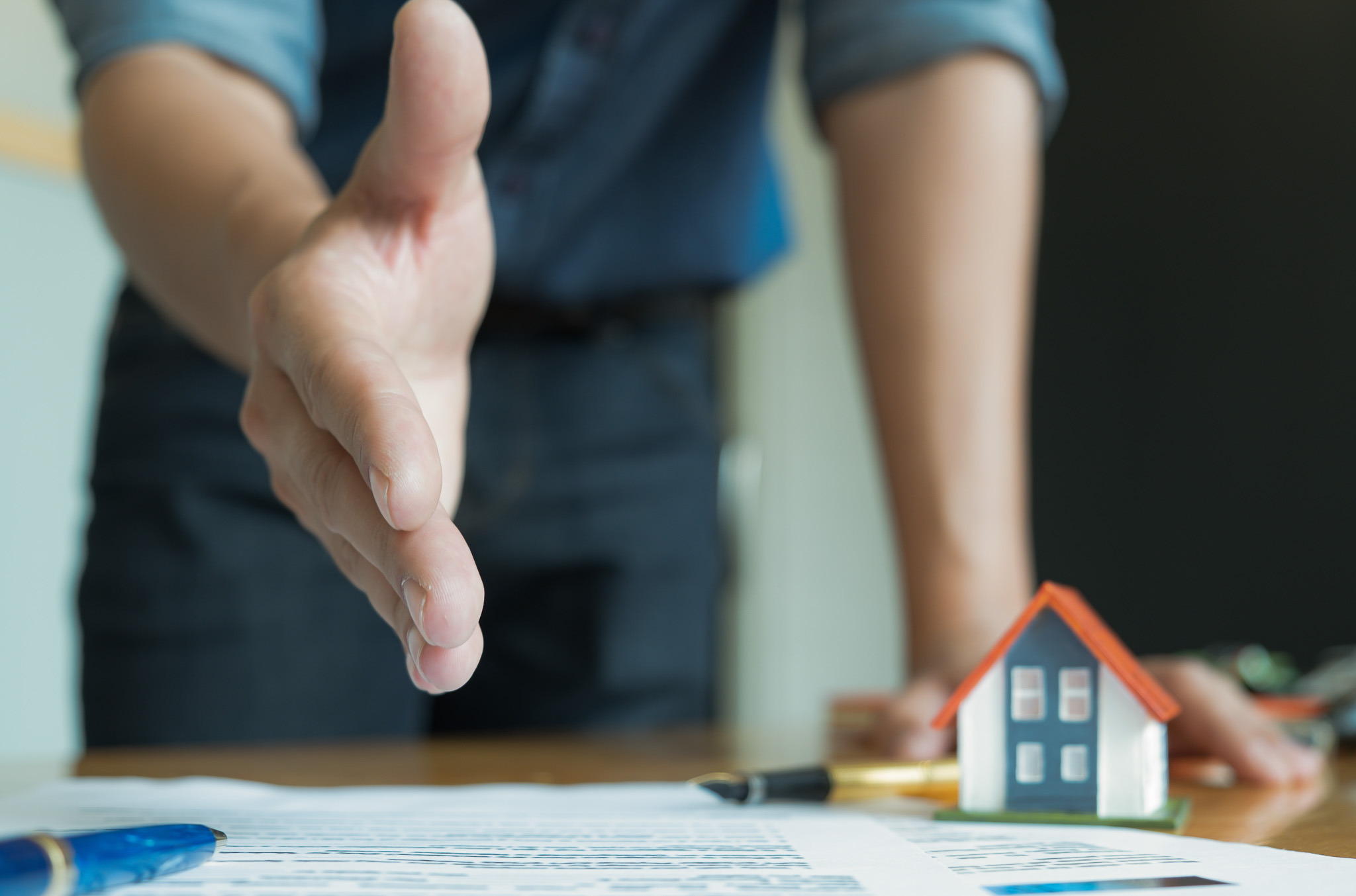 House sales staff extended their hands in front. Join hands with